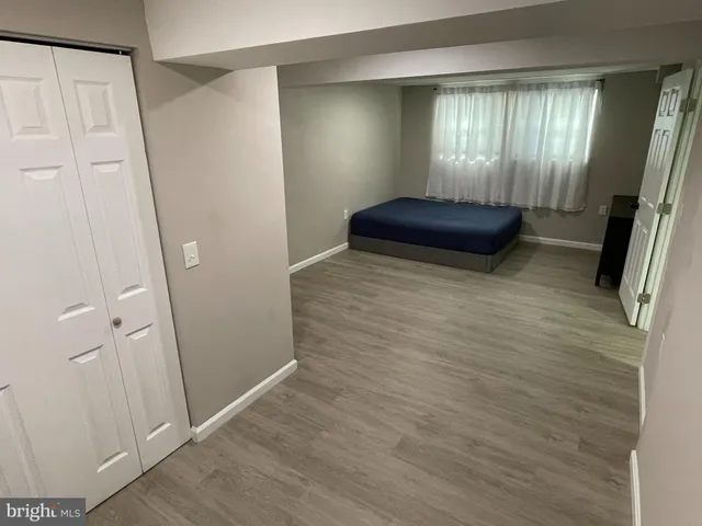 a view of hall way with wooden floor and staircase