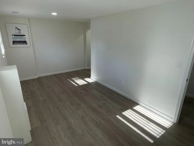 a view of wooden floor and windows in a room