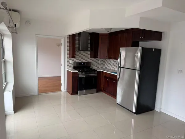 a kitchen with stainless steel appliances a refrigerator and a stove