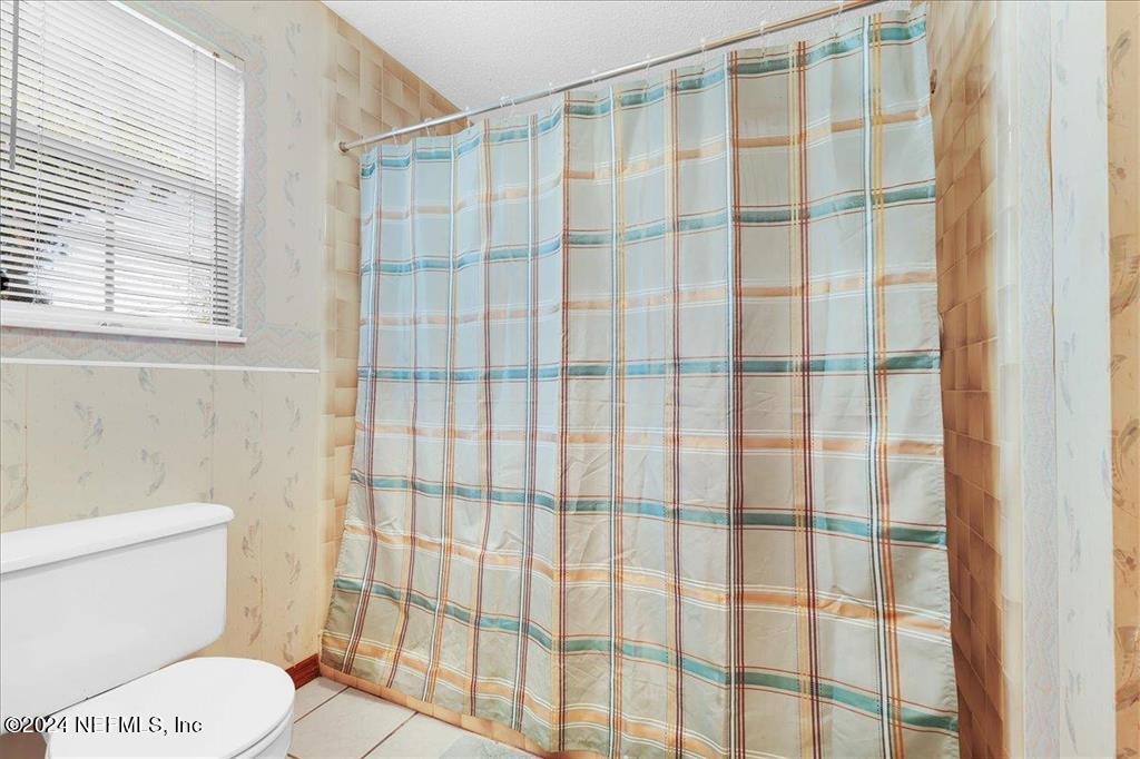 123 Unicorn Road St. Augustine, FL 32086 - Photo 13 of 51 a white toilet sitting next to a shower