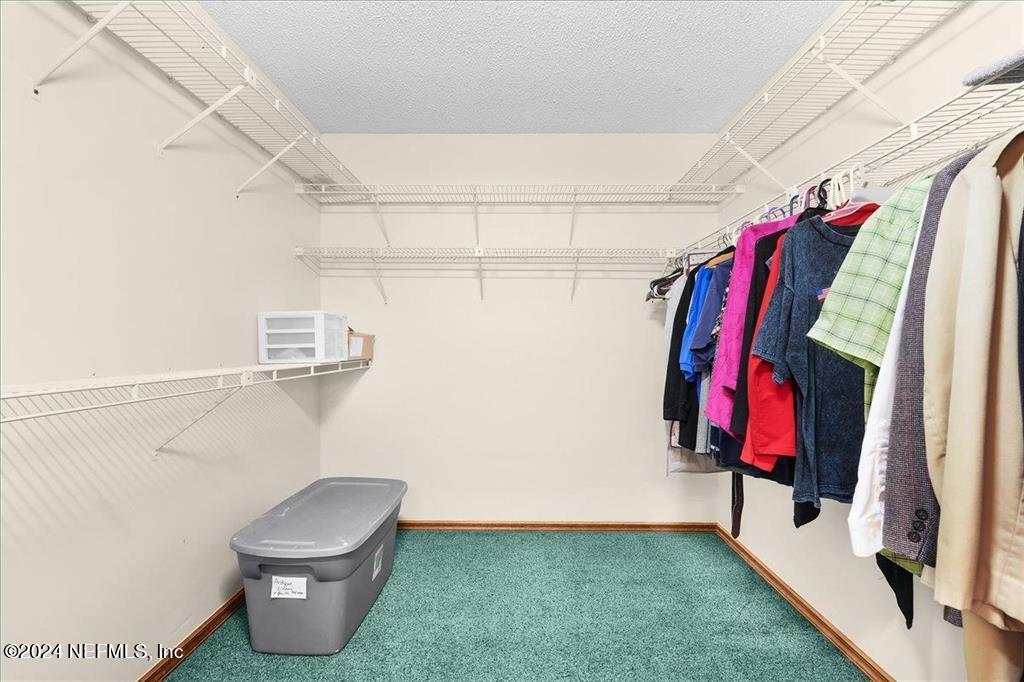 123 Unicorn Road St. Augustine, FL 32086 - Photo 14 of 51 a view of walk in closet with clothes and shoes