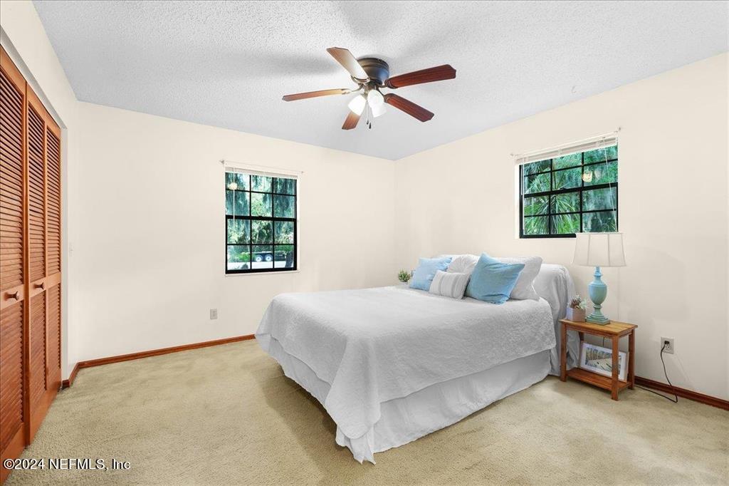 123 Unicorn Road St. Augustine, FL 32086 - Photo 19 of 51 a bedroom with a bed and window