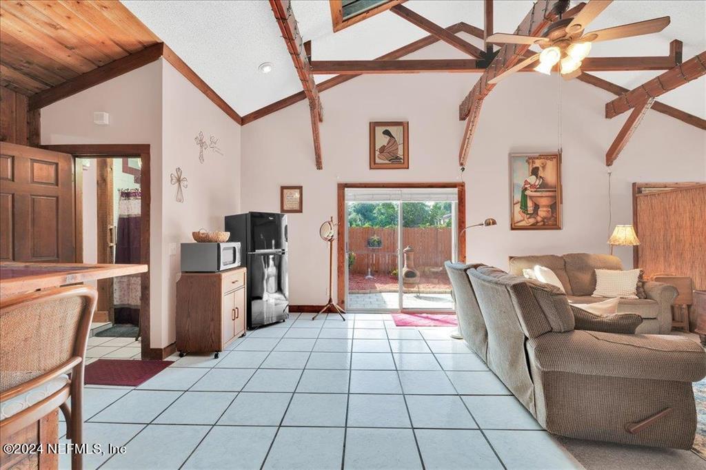 123 Unicorn Road St. Augustine, FL 32086 - Photo 21 of 51 a living room with furniture and a floor to ceiling window