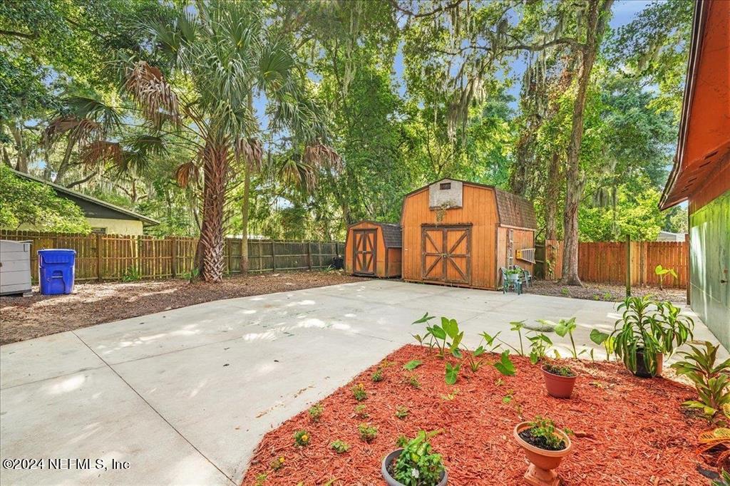 123 Unicorn Road St. Augustine, FL 32086 - Photo 39 of 51 a backyard of a house with large trees and plants