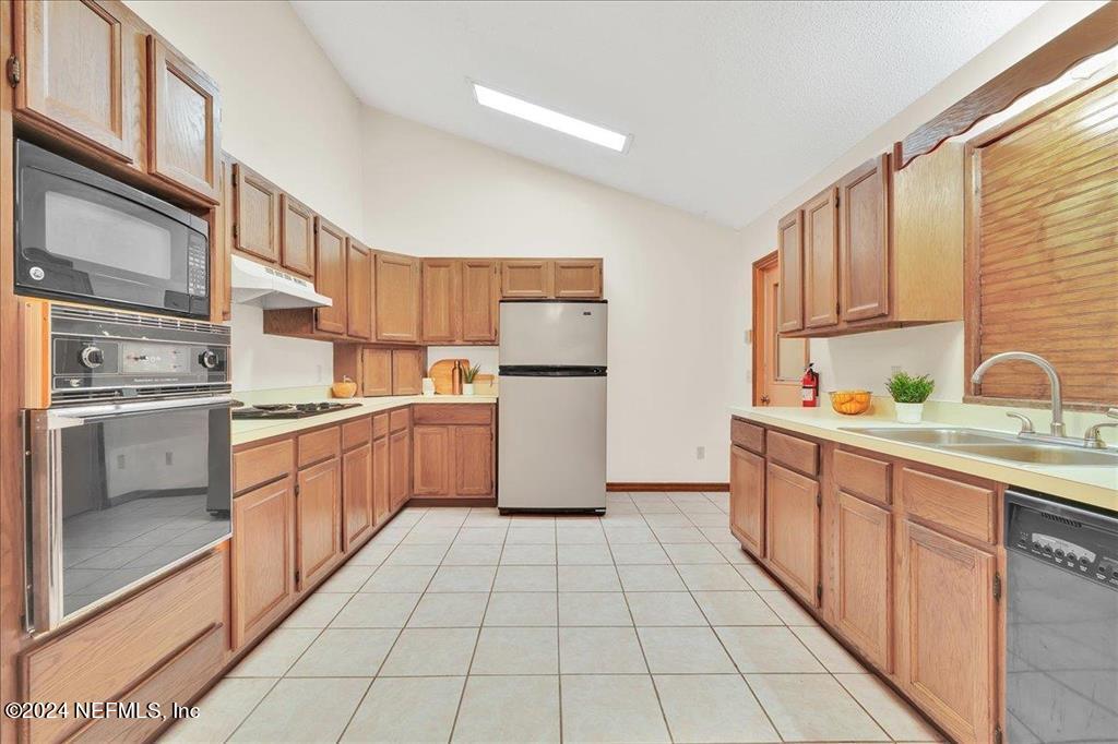 123 Unicorn Road St. Augustine, FL 32086 - Photo 7 of 51 a kitchen with a sink a stove top oven and cabinets