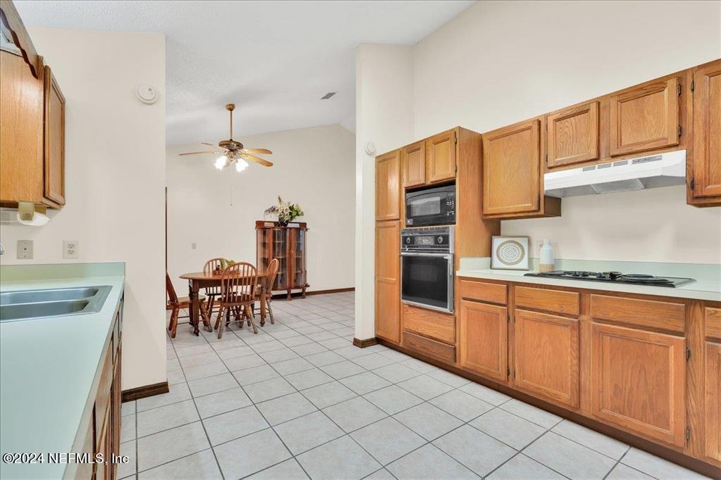 123 Unicorn Road St. Augustine, FL 32086 - Photo 8 of 51 a kitchen with stainless steel appliances granite countertop a sink and a refrigerator