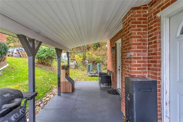 a view of a porch with chairs and backyard
