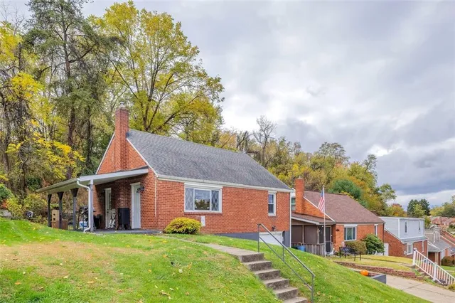a view of a house with a yard and sitting area