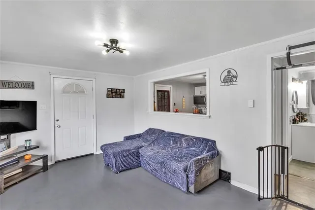 a living room with furniture and a flat screen tv