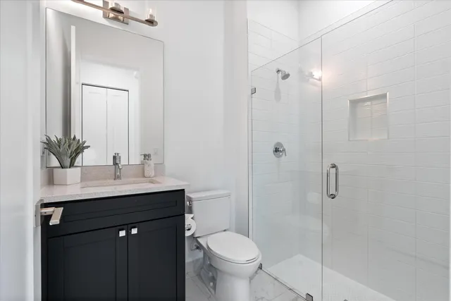 a bathroom with a sink toilet and shower