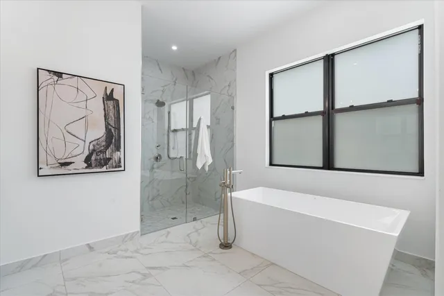 a bathroom with a bathtub and a shower