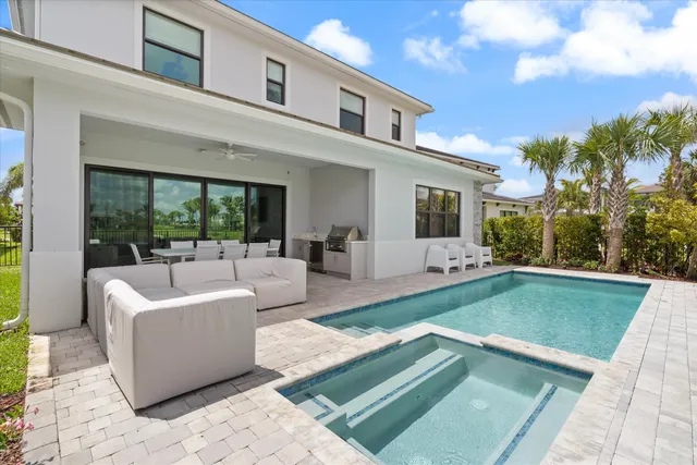 a swimming pool with outdoor seating and yard