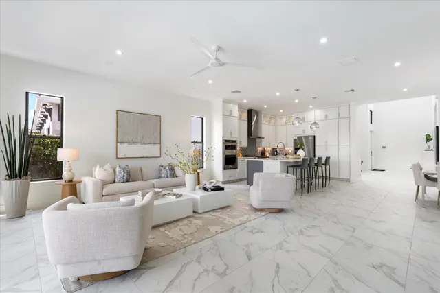 a living room with furniture and a view of kitchen