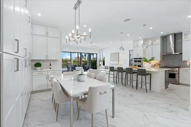 a large kitchen with kitchen island a table and chairs