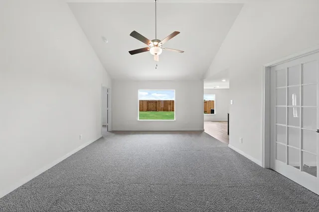 a view of a livingroom with a ceiling fan and window
