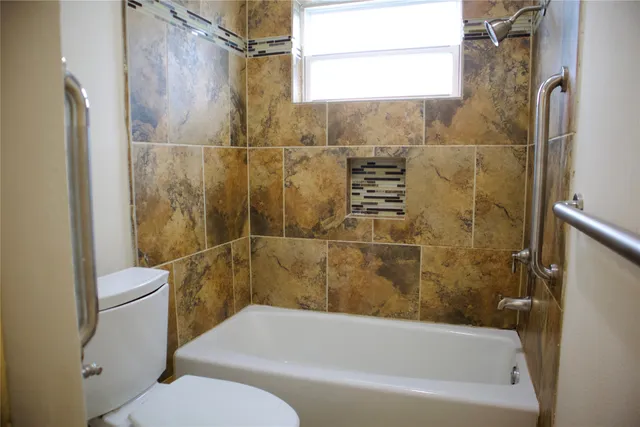 a bathroom with a toilet and shower