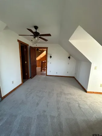 a view of a livingroom with a ceiling fan and window