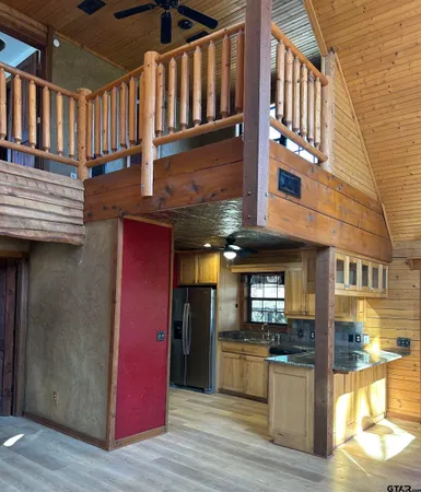 a kitchen with granite countertop a refrigerator and a sink