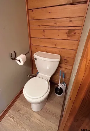 a bathroom with a toilet and a mirror
