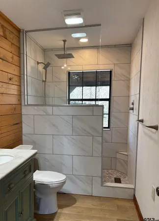 a bathroom with a toilet and a shower