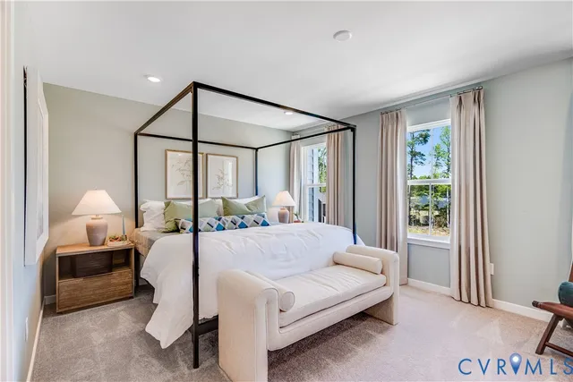 a bedroom with a large bed and a window