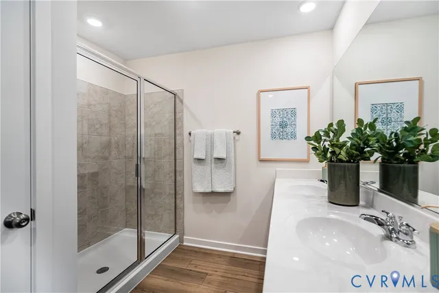 a bathroom with a shower a sink and a mirror