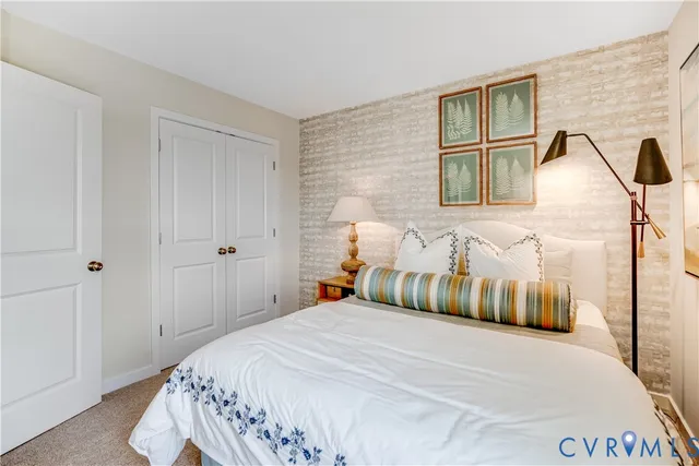 a bedroom with a bed and a night stand