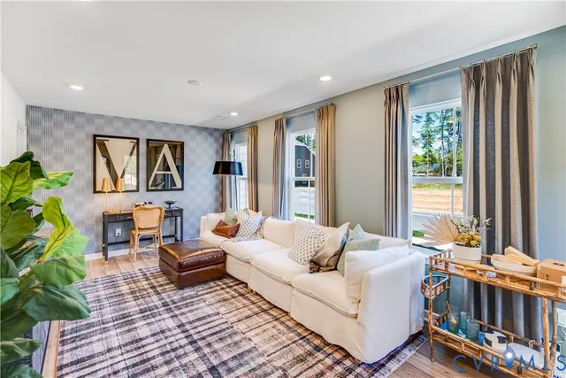 a living room with furniture and a large window