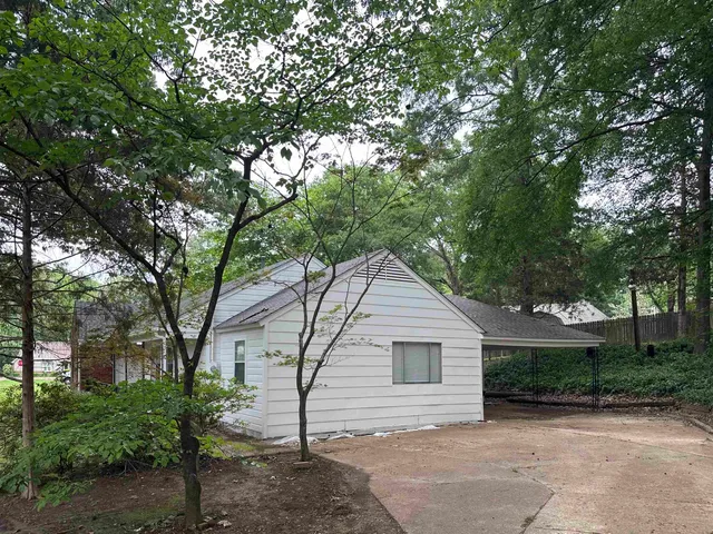 a view of a house with a tree in the background
