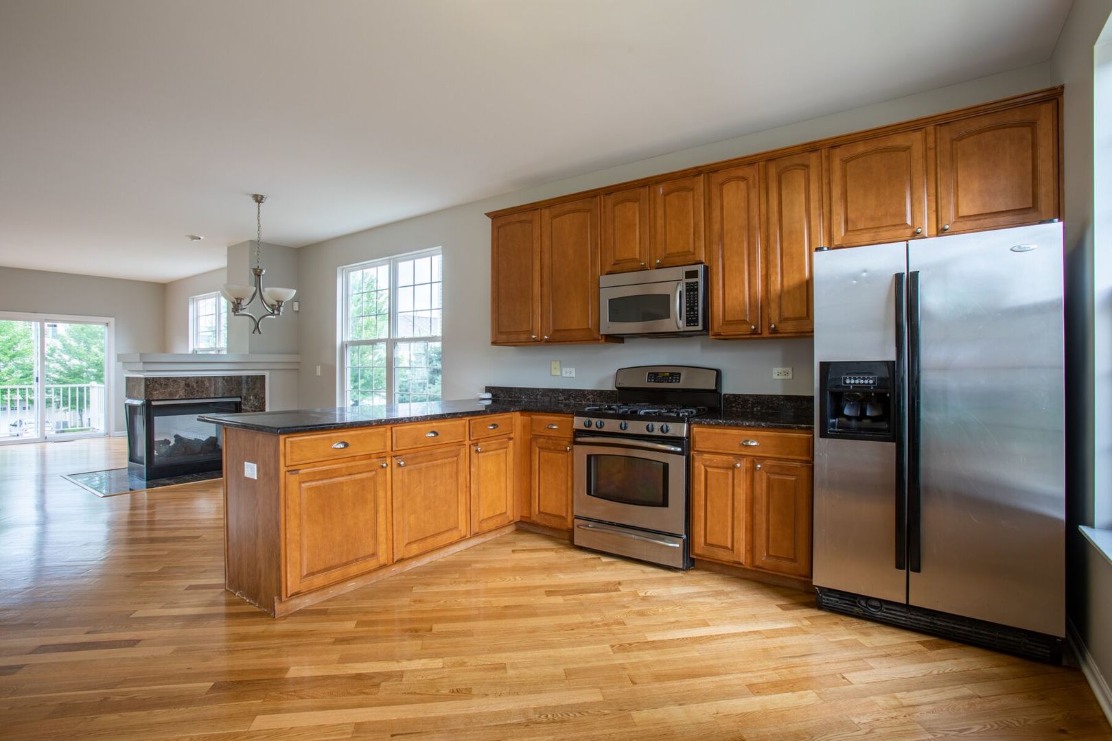 4125 Bethlehem Road Aurora, IL 60504 - Photo 3 of 19 a kitchen with granite countertop a refrigerator stove top oven and sink