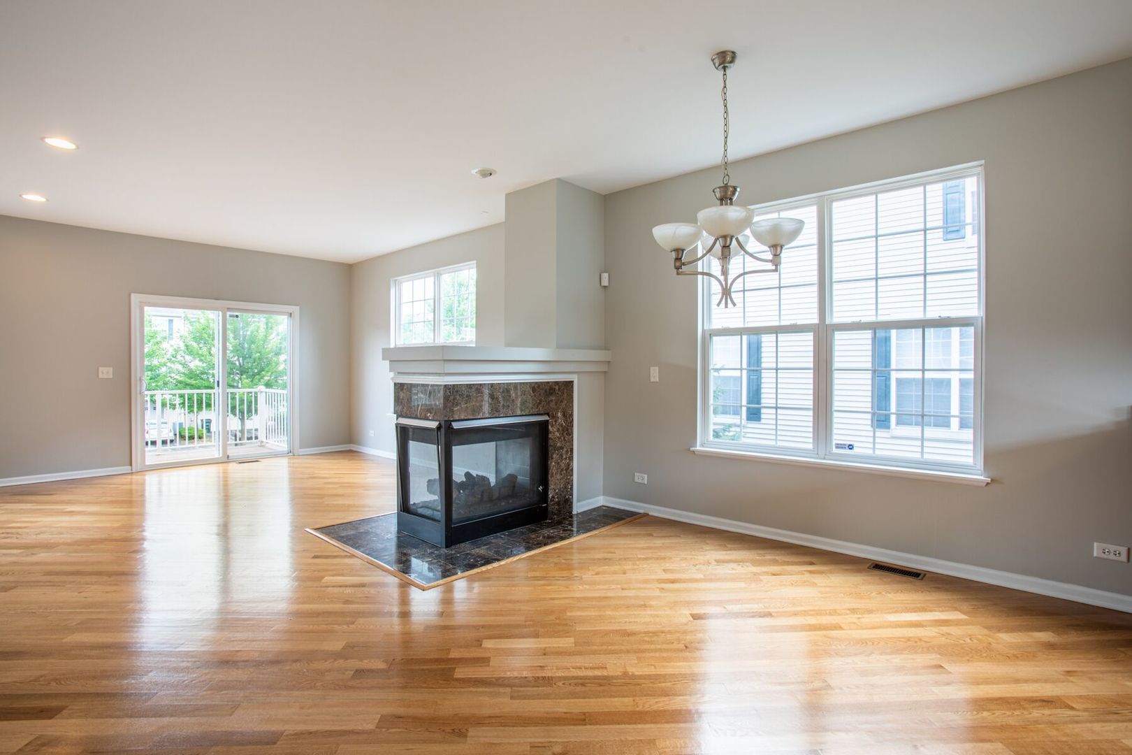 4125 Bethlehem Road Aurora, IL 60504 - Photo 7 of 19 a view of empty room with wooden floor and fireplace