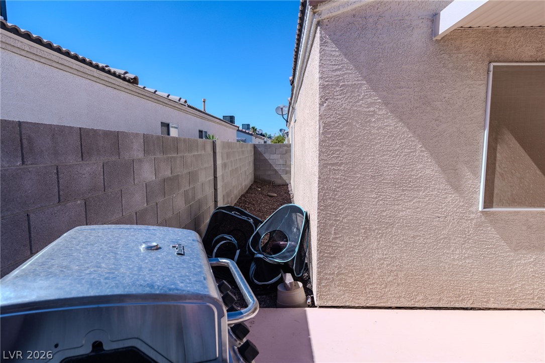 4994 Mascaro Drive Las Vegas, NV 89122 - Photo 24 of 30 A private outdoor space with a concrete block wall provides a secluded retreat for grilling.