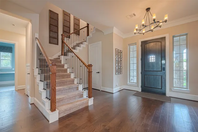 a front view of a house with a garden and plants