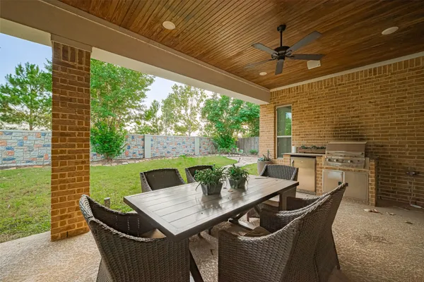 a view of a patio with couches table and chairs and potted plants