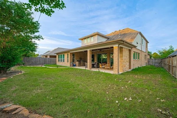 a view of a backyard with barbeque grill and a garden