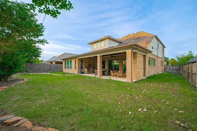 a view of a backyard with barbeque grill and a garden