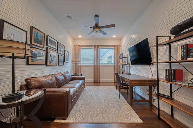 a view of a livingroom with wooden floor and stairs