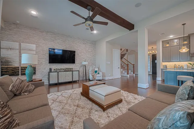 a living room with furniture tv and a window