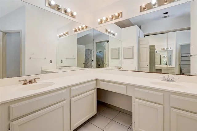a spacious bathroom with a sink and a mirror
