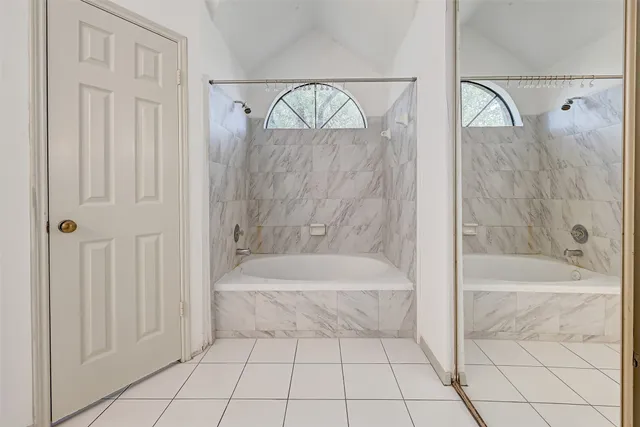 a bathroom with a bathtub and a shower