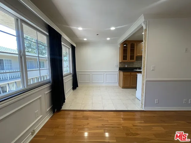 a view of a kitchen with a sink and a refrigerator