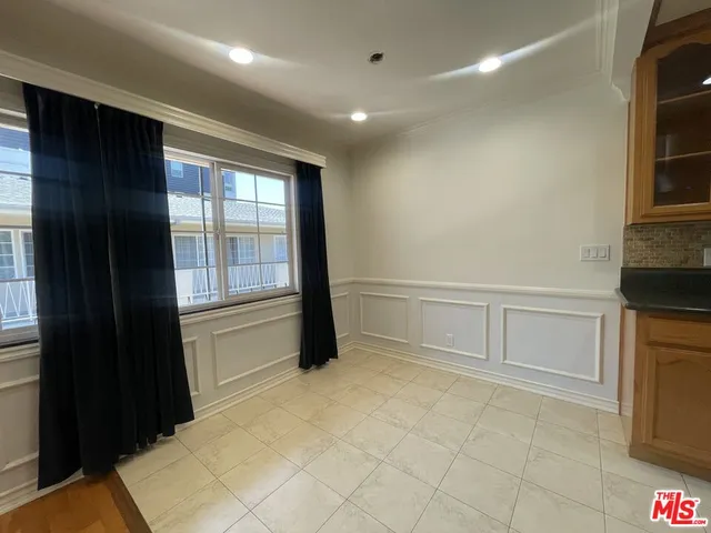 a view of an empty room with a kitchen