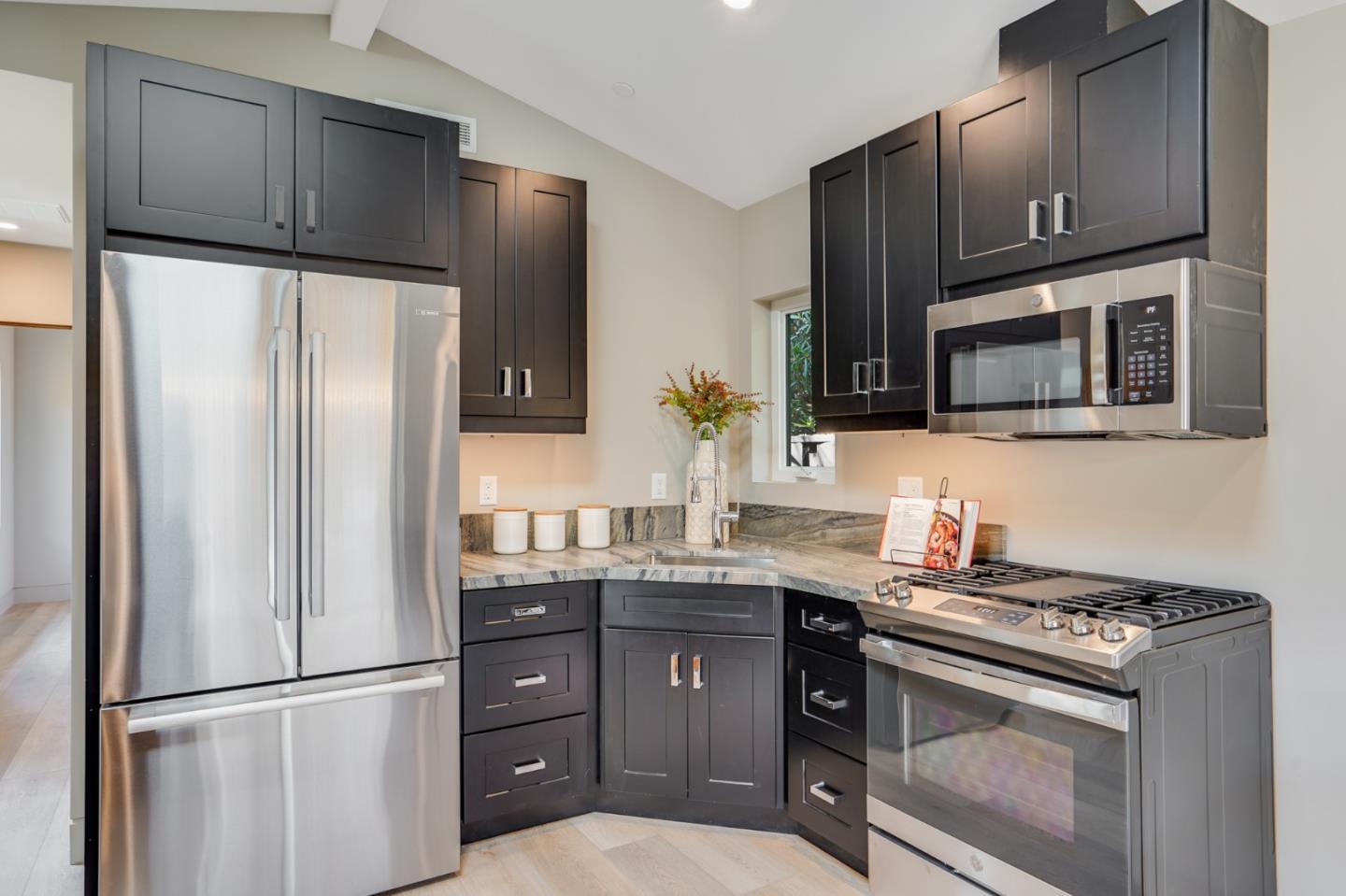 67 Lyell Street Los Altos, CA 94022 - Photo 24 of 31 a kitchen with stainless steel appliances granite countertop a refrigerator stove and microwave