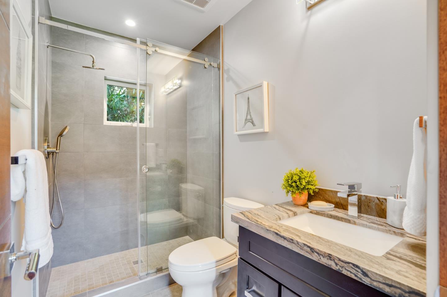 67 Lyell Street Los Altos, CA 94022 - Photo 29 of 31 a bathroom with a granite countertop sink a toilet and shower