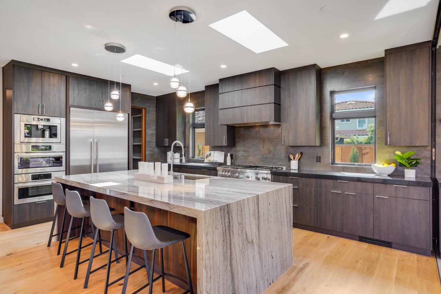67 Lyell Street Los Altos, CA 94022 - Photo 6 of 31 a kitchen with stainless steel appliances granite countertop a kitchen island a stove and a sink