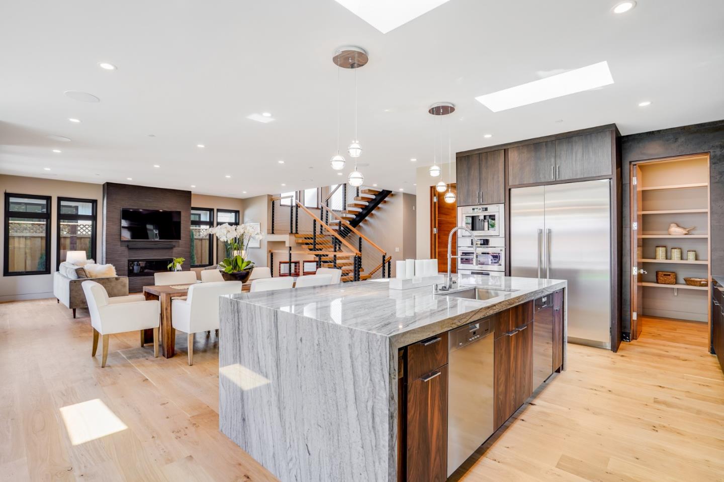 67 Lyell Street Los Altos, CA 94022 - Photo 7 of 31 a kitchen with stainless steel appliances kitchen island granite countertop a table and chairs in it