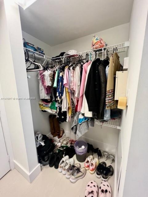 1200 Brickell Bay Drive, Unit 2008 Miami, FL 33131 - Photo 13 of 37 a view of walk in closet with clothes and shoes