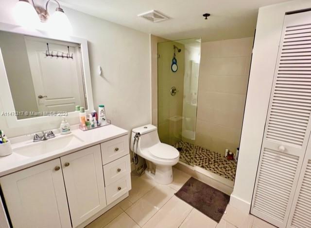 1200 Brickell Bay Drive, Unit 2008 Miami, FL 33131 - Photo 16 of 37 a bathroom with a double vanity sink toilet and shower