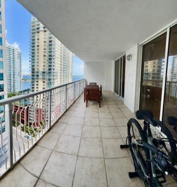 1200 Brickell Bay Drive, Unit 2008 Miami, FL 33131 - Photo 19 of 37 a view of a chairs and table in a room with a window