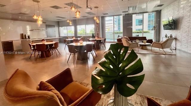 1200 Brickell Bay Drive, Unit 2008 Miami, FL 33131 - Photo 20 of 37 a living room with lots of furniture and a large window